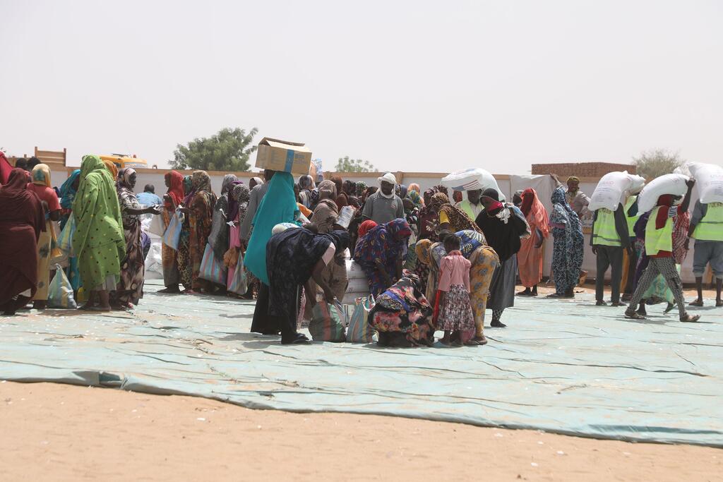 Sudanese refugees queue up for food at a distribution point in Adre, a Chadian town on the border with Sudan.